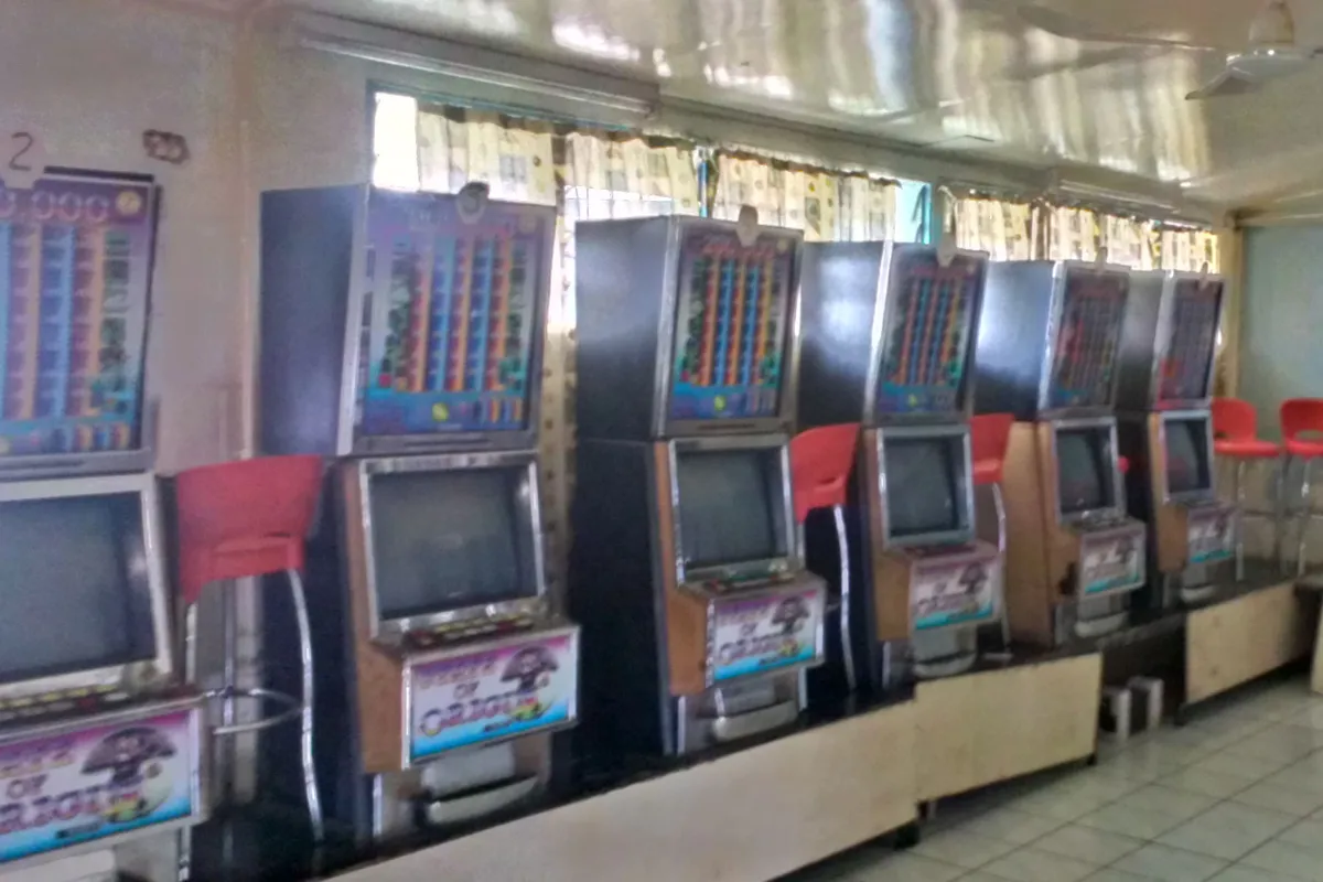 A row of video poker machines with stools in a club pokies room