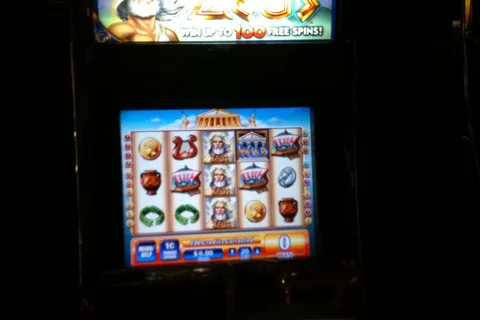 Zeus video pokie with its reels and bet panel lit up on the screen