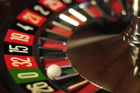 Close-up of a spinning roulette wheel with the ball near zero