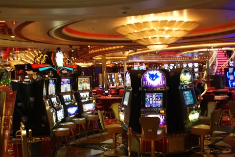 Slot machines under chandeliers in a cruise ship casino